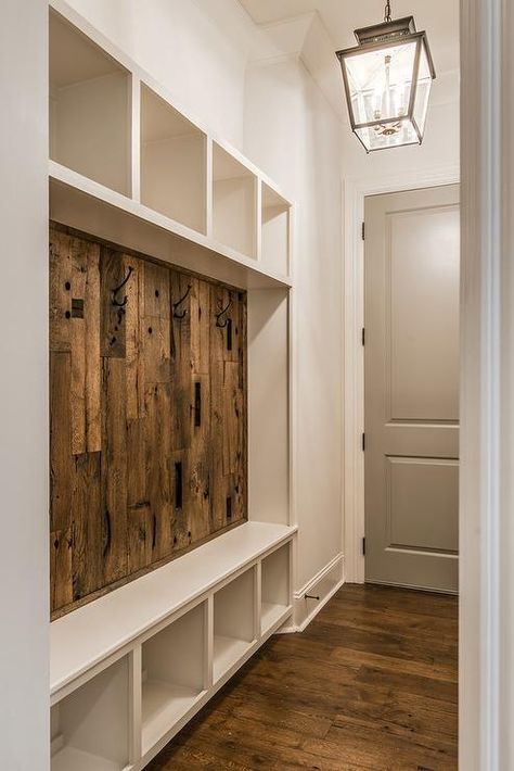 Rustic mudroom features a carriage lantern a built-in mudroom bench fitted with a barn wood backsplash sandwiched between by open shelving. Vstupná Hala, Farmhouse Mudroom, Barn Wood Decor, Minimalist Dekor, Interior Design Minimalist, Mudroom Entryway, Mudroom Decor, Mudroom Laundry Room, Interior Minimalista