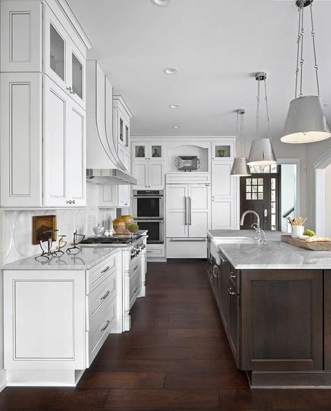 Large white kitchen boasts an exquisite dark brown island topped with white marble countertops holding a farmhouse sink fitted with a polished nickel gooseneck faucet illuminated by three Lily Hanging Shades. Large White Kitchen, Kitchen With White Cabinets, Brown Kitchen Cabinets, Refacing Kitchen Cabinets, Kitchen Diy Makeover, Diy Kitchen Renovation, Farmhouse Kitchen Cabinets, Brown Kitchens, New Kitchen Cabinets