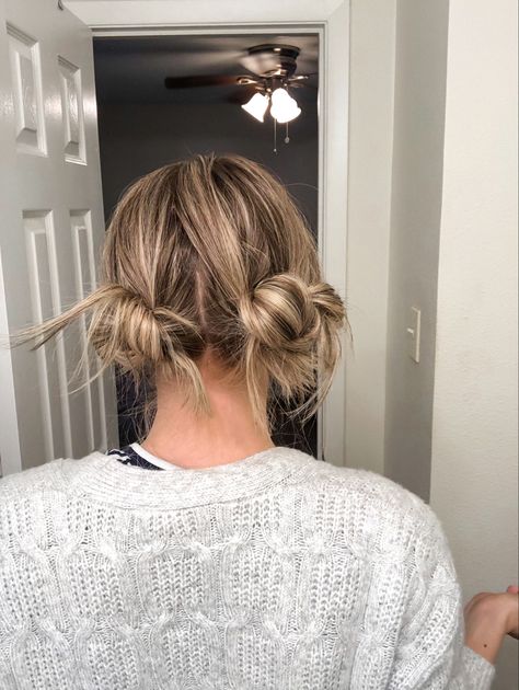 The more adult appropriate fun bun or space buns. This two low bun do is a simple hairstyle that will stay put all day long. Low Pigtail Buns Short Hair, How To Do Messy Low Space Buns, Low Messy Bun Pigtails, Two Buns Outfit, Messy Low Pigtail Buns, Space Buns That Stay, Double Buns Short Hair, Low Pigtail Bun Hairstyles, Grown Up Space Buns