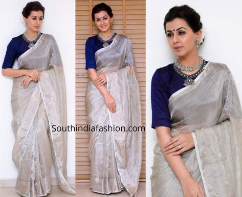 For a recent event, Nikki Galrani wore a plain silver tissue saree with contrast blue raw silk elbow length sleeves blouse by Anju Shankar. She styled her look with silver jewellery by Prade jewels, blue bindi and a gajra bun! Blouse For Silver Saree, Silver Tissue Saree Blouse Designs, Silver Saree Blouse Design, Silver Saree Look, Tissue Saree Blouse Designs, Silver Tissue Saree, Silver Saree, Kerala Saree Blouse Designs, Saree Blouse Styles