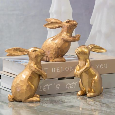 PRICES MAY VARY. Size: The gold rabbit figurines come as a set of 3. They are made of durable resin material with three different gestures. From left to right, the size of each item is about 4.1 inches in height and 1.7 inches in width, 2.9 inches in height and 1.7 inches in width, and 3.8 inches in height and 1.7 inches in width. Vintage Features: Exquisite and lovely bunny decor with antique finish in a vintage style, are a perfect choice for Easter theme decor and part of a spring centerpiece Statue Table, Gold Rabbit, Easter Bunny Figurines, Rabbit Statue, Bunny Statue, Spring Centerpiece, Ceramic Bunny, Rabbit Decor, Bunny Figurine