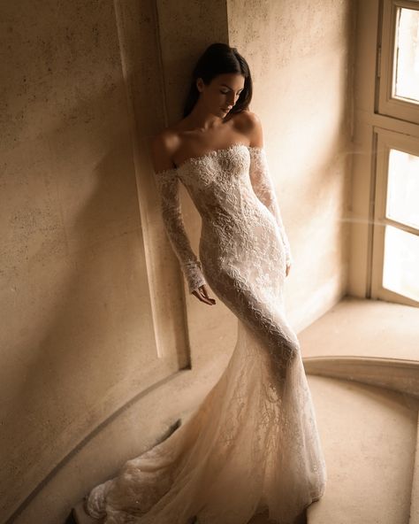 Embodiment of timeless elegance and romance. The Fall/Winter 2025 collection proposes a new vision for the modern bride with the #Charlotte gown, a mermaid silhouette featuring a straight neckline and graceful off-the-shoulder sleeves. Made from exquisite lace and adorned with intricate beaded details, this gown captures the essence of luxury. Complemented by a matching veil, the Charlotte gown embodies the enchanting beauty and profound emotions of the bridal journey. #LPGfall25 #BridalCou... Wedding Dresses Sofia Richie, Ethereal Wedding Dress Mermaid, Wedding Dresses Lace Aesthetic, Mesh Lace Wedding Dress, Wedding Siren Dress, Gaia Wedding Dress, Thomas Sebastian Wedding Dress, Wedding Dress With Neck Collar, Bardot Lace Wedding Dress