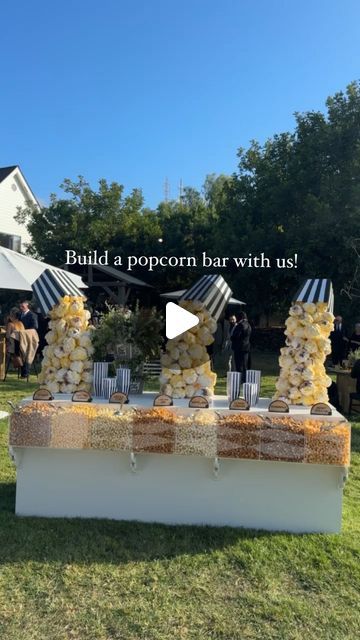 Revelry Event Designers on Instagram: "Ready for a pop of fun? 🍿

This custom popcorn bar was a crowd favorite at this ranch wedding! Our carpentry team crafted unique popcorn sculptures which we hand-painted for a playful look. With eight different flavors to choose from, it was a tasty, creative twist that guests couldn’t get enough of! 

The Team |
Planning & Design: @eventlab1
Event Design & Custom Bar: @revelryeventdesign @revelrymilana
Floral Design: @butterfloral @butterflyfloral_yvonne
Lighting & AV: @images_lighting @rayoflighting
Signage: @velvetfoxdesigns
Popcorn: Laguna Popcorn

#revelryeventdesign #custombar #customweddingdecor #popcornbar #eventbar #weddingdecor #weddingdecorideas #luxuryeventdesign #luxuryweddingdesign #customeventdecor #eventrentals #weddingbar #weddingbts Make Your Own Popcorn Bar, Popcorn Buffet Ideas, Popcorn Wedding Bar, Event Bar Design, Wedding Popcorn Bar, Popcorn Buffet, Party Food Bars, Popcorn Wedding, Custom Wedding Decor