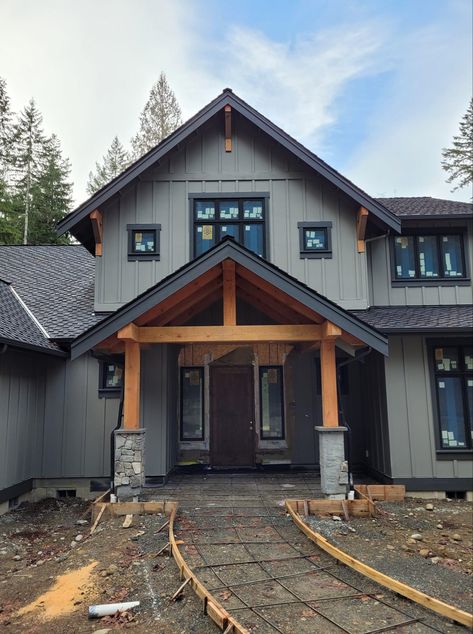 Batten Board House Exterior, Charcoal Farmhouse Exterior, Dark Gray Siding With Wood Accents, Dark House Exterior With Wood, Navy Blue Barndominium, Cabin Colors Exterior, Light Gray Barndominium Exterior, Black Board And Batten Exterior, Light Grey Barndominium Exterior