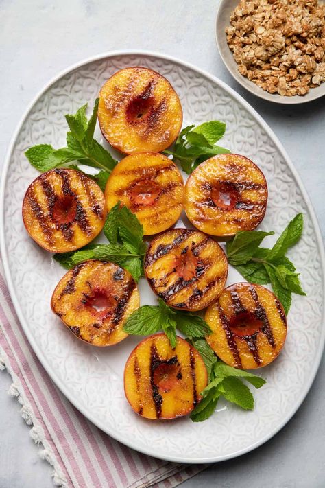 This simple summertime dessert is so effortless to make. Cinnamon and brown sugar grilled peaches served with ice cream, granola & fresh mint | Easy Desserts | Grilled Fruit | Grilling Ideas | No Bake Desserts | Fruity Desserts | Summertime Desserts Healthy Peach Recipes, Grilled Peaches Recipe, Summertime Desserts, Suddenly Salad, Grilling Ideas, Aip Desserts, Healthier Desserts, Grilled Fruit, Healthy Grilling