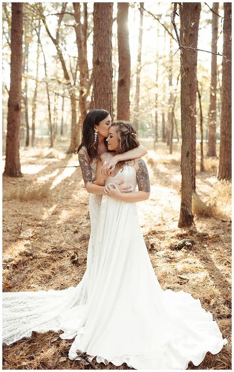 Romantic lesbian wedding photo of two brides their outdoors wedding in the woods decorated with white arch and flowers | Earthy Fall Wedding Inspiration with Organic Details - Love Inc. Mag - LAURA POWERS PHOTO Two Brides Wedding Photography, Lesbian Wedding Party Photography Poses, Cottage Core Lesbian Wedding, Lesbian Wedding Photoshoot Photo Ideas, Wedding Festival Theme, Wedding Photos Lesbian, Lesbian Fall Wedding, Lesbian Wedding Photography Poses, Earthy Fall Wedding