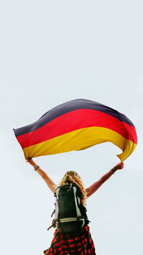 Download premium image of Woman holding the German flag by Jubjang about germany, adventure, background, backpack and backpacker 1214191 Gold Iphone Wallpaper, Flag Germany, Singapore Flag, German Study, Germany Football, German People, Germany Flag, German Flag, Germany Castles