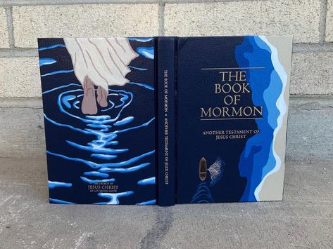 This is a hand-painted hard cover Book of Mormon with acrylic paint and protected with sealant! Perfect gift for family, friends, and missionaries! It was so fun to create. Ever since my mission in Alaska I have been painting more and more. I hope you enjoy my creations! Book Of Mormon Cover Painting Ideas, Hand Painted Book Of Mormon Cover, Book Cover Painting, Book Of Mormon Art, Book Of Mormon Painting Ideas, Painted Book Of Mormon Cover For Boys, Simple Book Of Mormon Painting, Book Of Mormon Painting, Paint Book Of Mormon