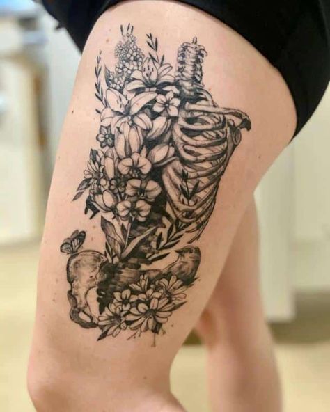 Beloved Tattoo and Removal Studio 3 Thigh Skeleton Tattoo, Skeletal Flower Tattoo, Grave Into Garden Tattoo, Half Skeleton Half Human Tattoo, Anatomical Skeleton Tattoo, Skeleton Memorial Tattoo, Botanical Skeleton Tattoo, Rib Cage With Flowers Tattoo, Skull And Plants Tattoo