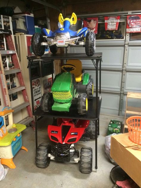 Power wheels space saving storage.  I got tired of the power wheels taking up so much room in the garage so I screwed these card tables on top of each other.  Works great and saves a ton of space. Power Wheels Storage Garage, Power Wheels Storage Outdoor, Power Wheels Storage, Slat Wall Storage, Wheel Storage, Kids Garage, Easy Garage Storage, Power Wheel, Garage Screen Door