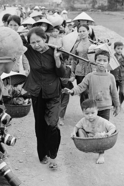 Refugees From The Besieged Quang Tri Original Caption: HIGHWAY ONE, SOUTH VIETNAM: Carrying their possessions, and in some cases, their children, refugees from the besieged Quang Tri province in South Vietnam along Highway 1 toward Hue City April 3rd. Communist troops outflanked Vietnamese defense lines and captured a key outpost 18 miles west of Hue April 4th. Vietnam Black And White, Human Migration, Ancient Vietnam, Vietnam History, White Pictures, South Vietnam, Historical Pictures, Vietnam Travel, Historical Events