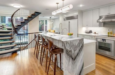 Contemporary kitchen with waterfall countertop and calacatta black marble and maple wood flooring Maple Wood Flooring, Waterfall Island Kitchen, Waterfall Countertop, Maple Hardwood Floors, White Marble Kitchen, Waterfall Island, Island Countertops, Countertop Design, Modern Kitchen Cabinets