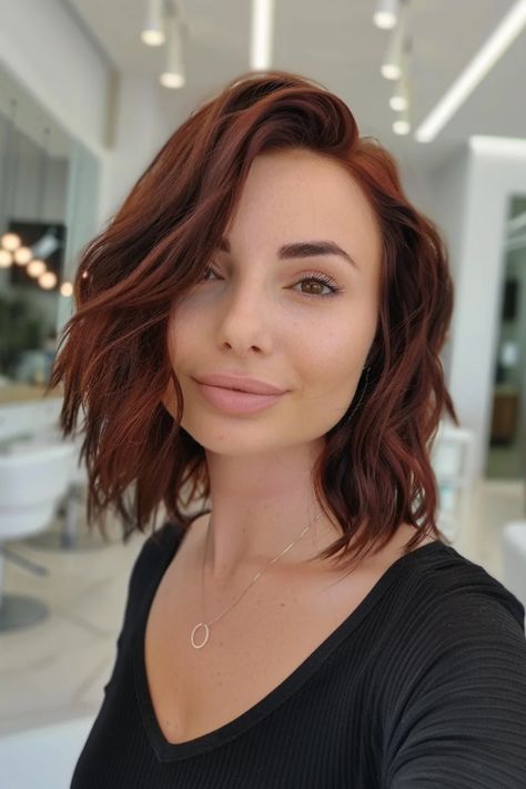 Woman with wavy auburn hair and a black top smiling in a bright salon. Solid Chocolate Brown Hair, Light Reddish Brown Hair Color, Warm Chocolate Brown Hair, Mocha Balayage, Reddish Brown Hair Color, Chocolate Brown Hair Color Ideas, Balayage Styles, Dark Chocolate Hair, Natural Looking Highlights