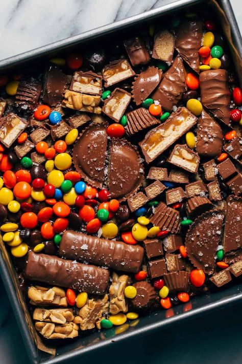 Not sure what to do with that bowl of leftover Halloween candy sitting on your counter? Put them to good use with these loaded halloween candy cookie bars! Soft and chewy bars are baked with chopped bits of candy inside and decorated with even more candy on top. #halloweencandy #cookiebars #candybars #candy #butternutbakery | butternutbakeryblog.com Candy Cookie Bars, Chewy Bars, Butternut Bakery, Candy Bar Cookies, White Chocolate Brownies, Leftover Halloween Candy, Gooey Cookies, Candy Cookie, Candy Cookies