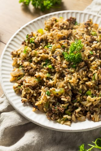 Dirty Rice is a Cajun Classic. Paula Deen's direty rice recipe uses chicken livers to give the rice its color. Can be used as a main or side dish. Pappadeaux Dirty Rice Recipe, Cajun Rice Recipe, Chicken Pilaf, Cajun Dirty Rice, Cajun Rice, Dirty Rice Recipe, Cajun Dishes, Dirty Rice, Fast Food Menu