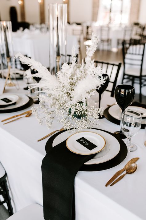 Black charger, white linen, white dishware, black napkin, with name card on top.

Photography // Anna Behning Photography 

Venue // The Atrium at Blue Haven 

Florals // Island Floral 

Stationery // Hitch Studio 

Decor & Backdrop // Hitch Studio 

Stationery Printing // Allegra Brookings

Black Chargers & Settee // Ideal Tent and Event Rentals

Napkins & Gold Candle Holders // Party Depot Black White And Gold Wedding Backdrop, Black And White Candle Wedding, White Charger Plates Wedding, Black Charger White Plate Wedding, Black Charger Plates Wedding Table Settings, White Linen Black Napkin Wedding, Champagne White And Black Wedding, Black Gold And White Table Setting, Black Napkin Table Setting