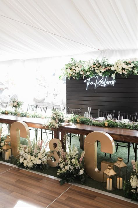 Bride And Groom Backdrop Reception, Head Table Wedding Decorations Greenery, Head Table With Backdrop, Wedding Sign Behind Head Table, Wedding Backdrop Behind Sweetheart Table, Front Table Decor Wedding, 4 Person Head Table Wedding, Neon Sign Behind Head Table, Bride And Groom Table Neon Sign