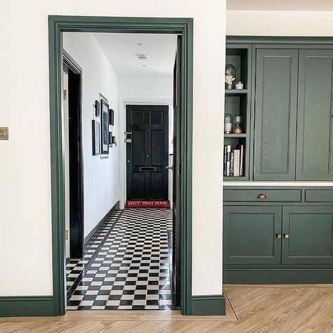 monochrome hallway Green Woodwork Hallway, White Walls Green Woodwork, Hallway Coloured Woodwork, Olive Green Skirting Boards, Dark Painted Woodwork, Hallway Dark Woodwork, Dark Woodwork Living Room, Farrow And Ball Doors Internal, Dark Green Panelling Hallway