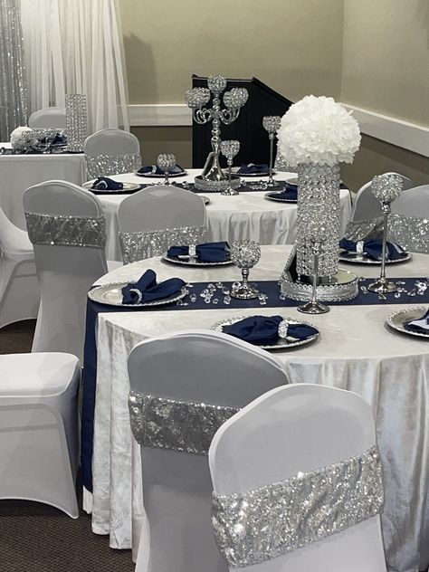 Blue Silver And White Table Decor, Diamond Gala Theme, Royal Blue Decorations Party Quince, Navy And Silver Wedding Decorations, Midnight Blue And Silver Wedding Theme, Senior Serve Table Ideas High Schools, Denim And Diamonds Table Decor, Silver And Blue Wedding Theme, Silver And White Centerpieces