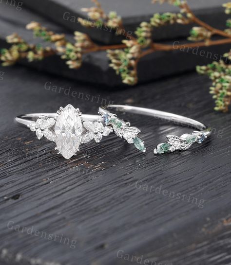 Marquise cut Moissanite Engagement ring set Vintage moss agate wedding band White gold Cluster shank Unique leaf Bridal set Anniversary gift ABOUT THIS RING Beautiful Moissanite engagement ring Set -------------------------------------------------------- 「Product Summary」 Engagement Ring * Center Stone: 5*10mm moissanite OR Simulated Diamonds  (Marquise cut) * Side Stones: 1.5*3mm Marquise cut Moissanite                           1.7mm Round Moissanite Or Side Stone: Simulated Diamond * Total Ca Wedding Band For Marquise Ring Silver, Marquise Leaf Ring, Uncut Diamond Rings, Marquise Flower Ring, Whimsical Wedding Ring Set, Engagement Rings Silver Marquise, Marquise Engagement Rings Silver, Fairy Wedding Rings Silver, Moissanite Engagement Ring Stack