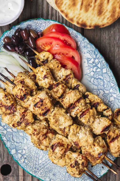 Greek Chicken Souvlaki Recipe with Tzatziki | The Mediterranean Dish Recipe Tzatziki, Greek Chicken Souvlaki Recipe, Recipe With Tzatziki, Chicken Souvlaki Recipe, Souvlaki Marinade, Greek Chicken Souvlaki, Souvlaki Recipe, Mediterranean Foods, Chicken Souvlaki