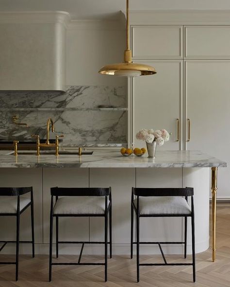 Meg Cassidy on Instagram: "For this Toronto kitchen, our intention was to draw inference from classical European influences. The herringbone floor and Venetian plaster hood brought texture to the space paired with the old world feel of unlacquered brass fixtures and those island legs, well they are just magical. ✨  Adjacent to the kitchen through an arched opening is a pantry clad in brass cabinets and a marble wall of shelves for all the curiosities.   Design | Studio Meg Cassidy Photography | @niamhbarryphoto" Plaster Cabinets, White Kitchen With Marble Countertops, Brass Cabinets, White Kitchen With Marble, Kitchen With Marble Countertops, Plaster Hood, Arched Opening, Kitchen With Marble, White Marble Kitchen