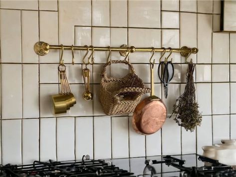 Looking to give your kitchen a vintage makeover? Enhance its aesthetic appeal with a brass pot and pan organizer from Kitchen Pot and Pan Hanger. Our unlacquered brass hanger and hooks offer the perfect look, handcrafted with exceptional attention to detail. Featuring a sturdy bar, heavy brackets, and well-shaped hooks, this masterpiece will elevate your kitchen's decor and become the star attraction. #brasspotrail #potrail #kitchen #hangingrail Pot And Pan Hanger, Brass Pot Rail, Pot And Pan Organizer, Pot Rail, Wall Mounted Kitchen Storage, Pan Hanger, Antique Brass Kitchen, Pan Organizer, Kitchen Rails