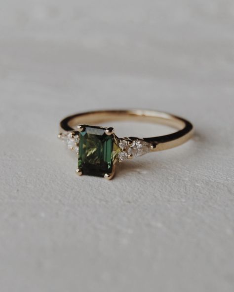 Congratulations Quin + Rae 🥹💍🍾 We customized our Elsie setting, switching out the centre stone for a stunning 6x4mm natural dark green tourmaline with pear and round accents. We wish you the best for your engagement season!! Engagement photos by the lovely: @jordanfayephotography Gold Engagement Ring Coloured Stone, Green Topaz Engagement Ring, Wedding Ring Green Stone, Gold Engagement Ring Colored Stone, Dark Emerald Engagement Ring, Vintage Green Engagement Ring, 4 Diamond Ring Design, Engagement Ring Green Stone, Gold And Green Engagement Ring