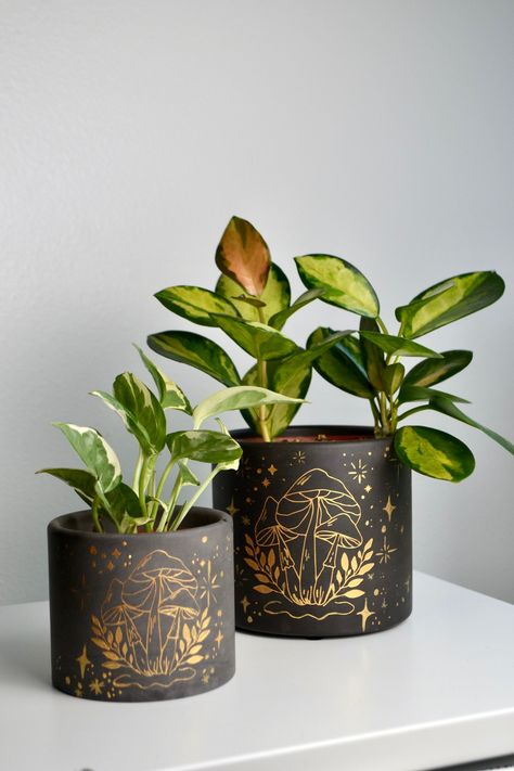 A Fall-themed plant is a must-have this season. These Painted Mushroom Planters are perfect for someone who wants to add some character to their home. Available in multiple sizes, these planters are made of durable cement that features felt feet as protection against scratches and scuffs. Details: Durable concrete material Multiple available sizes Felt feet prevent scratching or scuffing Mushroom Planter, Fall Pots, Mushroom Plant, Plant Pot Design, Plant Pot Diy, Flower Pot Design, Painted Pots Diy, Painted Plant Pots, Pot Crafts