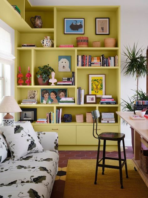 Display Corner Ideas, Funky Built In Shelves, Painted Wall Shelves, Coloured Bookshelves, Home Library Shelves, Bookshelf Eclectic, Sofa In Middle Of Living Room, Weird Corner In Living Room, Colored Bookshelf