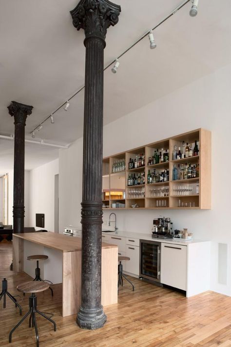 Open office loft, wood floors, white walls, cast iron columns, 13 ft high celings, maple kitchen island, open kitchen shelves, Magdalena Keck Temp Wallpaper, Columns Interior, Ny Loft, Cocina Shabby Chic, Wallpaper Waterproof, Kitchen Island On Wheels, Loft Office, Loft Kitchen, Minimal Kitchen