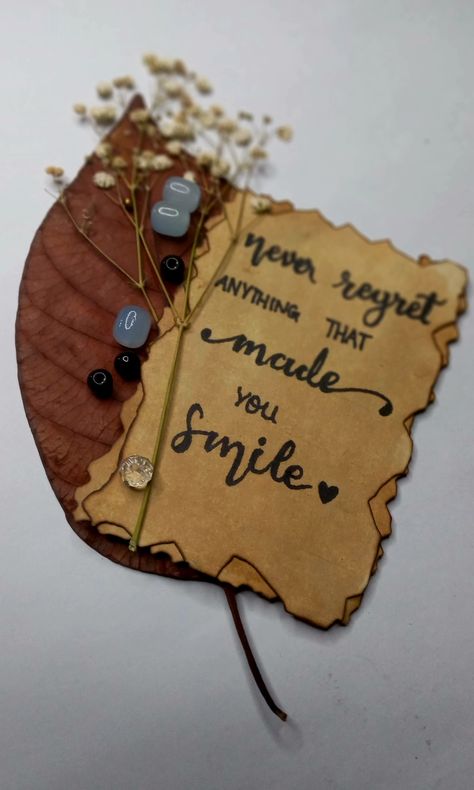 "Never regret anything made you smile". Calligraphy written on coffee stained thick paper and photographed with dry leafs and flowers beside beeds. Smile Calligraphy, Coffee Stained Paper, Never Regret Anything, Coffee Stain, Book Page Crafts, Make Smile, How To Write Calligraphy, Never Regret, Dry Leaf