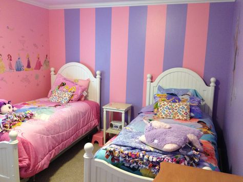 Room for twin girls. One wall is pink and one purple. One wall has the stripes and the wall you can't see is pink on top and purple on the bottom. Pink And Purple Striped Walls, Pink And Purple Painted Room, Pink And Purple Bedroom Walls, Pink And Purple Kids Bedroom, Pink And Purple Room Ideas Girly, Pink And Purple Wall Paint Ideas, Pink And Purple Kids Room, Pink And Purple Walls, Pink And Purple Bedroom Kids