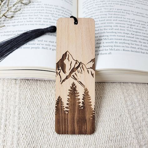 Add a touch of nature to your next novel with these beautiful eco-friendly wooden bookmarks. All bookmarks are engraved in-house using sustainably sourced American hardwood. After your new bookmark is engraved, it is finished with a black bookmark tassel. Best of all, this product is all-natural, so you can feel good about shopping small AND eco-friendly! Material: sustainable American hardwood, unfinished Sizing: 1.7 inch L x 5 inch W Thickness: 1/16 inch Diy Wooden Bookmark, Wood Burning Bookmark Ideas, Wooden Bookmark Ideas, Wooden Bookmarks Diy, Woodburn Bookmarks, Woodburned Bookmarks, Wood Burning Bookmarks, Small Wood Burning Ideas, Wood Burned Bookmarks