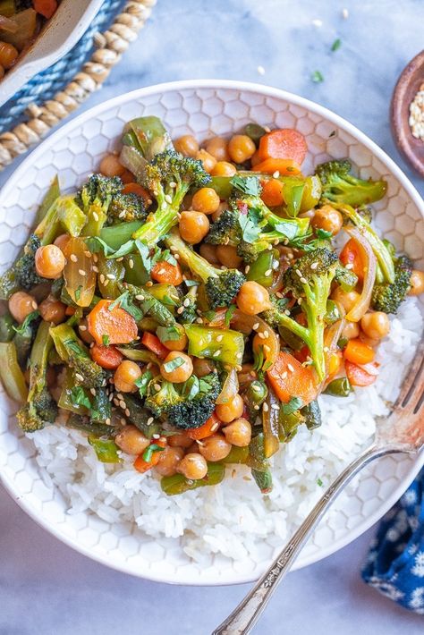 This Chili Garlic Vegetable Stir Fry with Chickpeas comes together in just 30 minutes and in one pan! It's easy to make, but big on flavor and is great when you have lots of vegetables in the refrigerator that need to be used up. Serve with rice or noodles and enjoy for lunches throughout the week, or a delicious weeknight dinner. #stirfryrecipe #veggiestirfry #chiligarlicsauce #vegan #weeknightdinner Chickpea Stir Fry, Chickpea Recipes, Veggie Stir Fry, Chili Garlic Sauce, Vegetable Stir Fry, Stir Fry Recipes, One Pan, Chickpeas, Weeknight Dinner