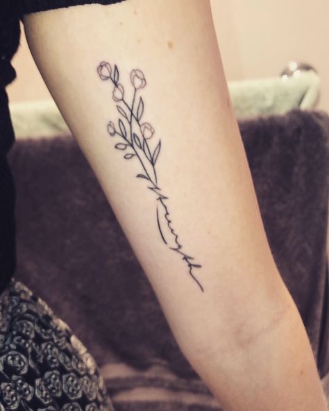 strength flower tattoo Small Tattoo Ideas Strength, Writing In Stem Of Flower Tattoo, Names Flower Tattoo, Flower With Faith Stem Tattoo, Flower Tattoo With Stem Writing, Cursive Name Tattoo With Flower, Vines With Words Tattoo, Flower Tattoo With Names In Stem, Word Vine Tattoo