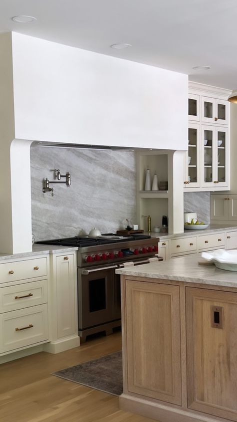 Creamy Kitchen; Kitchen Cabinets, wood island, hood, countertop inspo Range Hood Over Island Wood, White Cabinets With Black Island And Wooden Hood Vent, Wood Accent Kitchen, Island Cooktop With Hood, Island Kitchen Cooktop Vent Hood, Taj Mahal Kitchen, Flush Mount Island Range Hood, Tudor Renovation, Kitchen Cabinets Wood