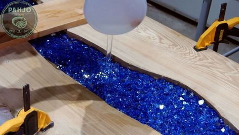 In this HT post, I show you how to make a glow in the dark epoxy bar top using reclaimed wood with embedded blue fire glass. Reclaimed Sinker Cypress WoodFirst, I used reclaimed sinker cypress wood for this epoxy bar top.  Obviously, I fell in love with the beauty of this reclaimed wood, which is pulled from the river bottom all along the gulf coast.I contacted a local Sinker Cypress Logger to purchase a slab for this live edge epoxy bar top using reclaimed wood.Ultimately, I… Epoxy River Bar Top, Epoxy Bar Top Ideas, Diy Bar Top, Epoxy Bar Top, Epoxy Counters, Glow In The Dark Epoxy, Trippy House, Sinker Cypress, Diy Garden Bar