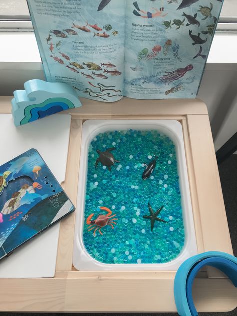 Kids sensory play bin, ocean themed. Waterbeads, ocean animals, books, and wooden stackers. Small world invitation to play Kids Sensory Play, Invitation To Play, Kids Sensory, Ocean Animals, Play Activities, Sensory Bins, Learning Through Play, Sensory Play, Infant Activities