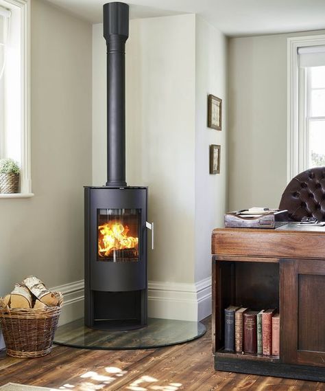 Wood burner ideas: 17 hot designs that will warm your heart and your home | Real Homes Woodburner In Kitchen, Blaze King Wood Stove, Corner Wood Stove Hearth Ideas, Wood Stove In Corner, Corner Wood Burning Stove Ideas, Corner Log Burner Ideas, Wood Burner Ideas, Free Standing Wood Burning Stove, Living Room With Wood Stove