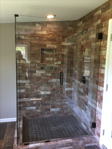 Here is the master bathroom at our lake house. I used the brick porcelain tile across one whole wall on the floor I used a 6" tile that looks like hardwoods. It looks soooo good. Brick Shower Ideas, Brick Shower Wall, Brick Tile Shower, Unique Sinks, Brick Face, Modern Bathroom Interior, Shower Designs, Brick Tile, Brick Backsplash