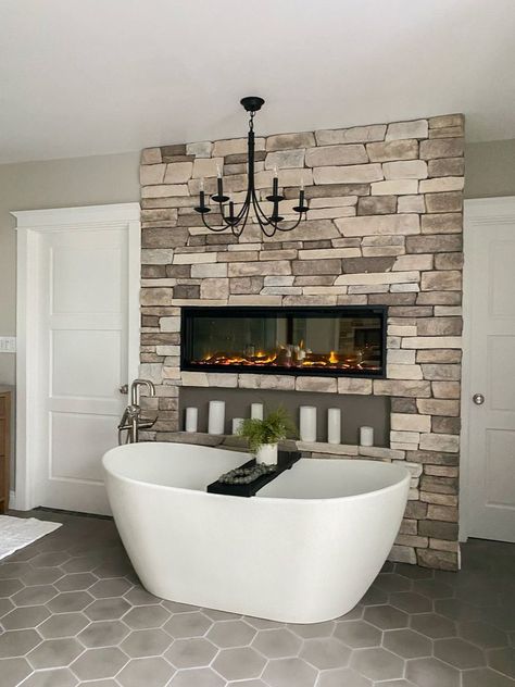 Beautiful master bathroom with a floating tub and fireplace. Large chandelier. Custom fireplace. Spa like master bathroom. Kylie Interiors, Master Bath Tub Ideas, Luxury Bath Tub, Fireplace Luxury, Master Suite Bathroom, Luxury Bathroom Tiles, Master Bath Renovation, Luxury Bathroom Master Baths, Luxury Master Bathrooms