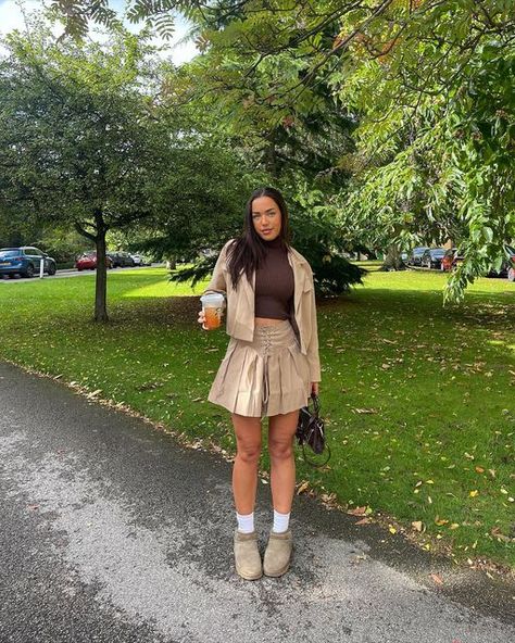 Khaki Skirt Outfit Winter, Tan Pleated Skirt Outfit, Khaki Uggs Outfit, Uggs And Mini Skirts, Khaki Pleated Skirt Outfit, Brown Pleated Skirt Outfit, Tan Skirt Outfit, Spring Brown Mini Pleated Skirt, Fall Brown Pleated Mini Skirt