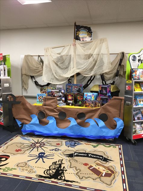 Pirate Book Fair Theme, Cardboard Shipwreck, Pirate Book Fair, Literacy Night Games, Ship Cardboard, Pirates School Theme, Pirate Ships Diy, Vbs Ocean Theme, Cardboard Pirate Ship