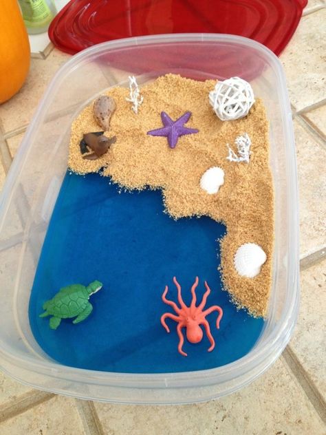 Beach sensory bin using blue jello for water, crushed graham crackers tossed with coconut oil for sand, ocean figures and shells Beach Sensory Bin, Edible Sensory, Summer Sensory, Healthy Food Activities, Frog Activities, Blue Jello, Pirates Party, Infant Room, Lesson Plans For Toddlers