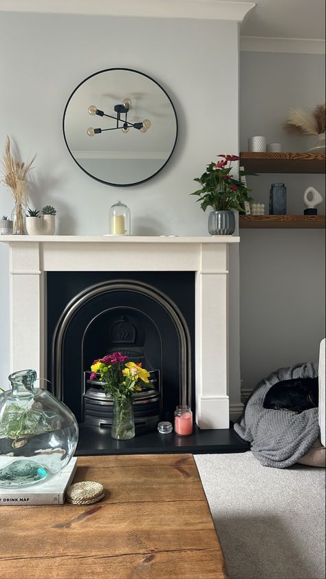 Fireplace arrangements, circle mirror above fireplace, white company place mats, large base, fresh flowers, candles Fireplace Arrangements, Mirror Above Fireplace, Fireplace White, Above Fireplace, Flowers Candles, Circle Mirror, White Company, The White Company, Place Mats