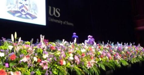 Graduation Ceremony Stage Design, Graduation Stage Decorations Flowers, Graduation Ceremony Decorations Stage, Graduation Floral Arrangements, Stage Decoration With Flowers, Graduation Stage Design, Graduation Stage Decorations Schools, Floral Stage Decoration, Graduation Ceremony Decorations