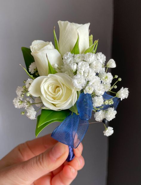 Wrist corsage and boutonniere pair of white spray roses, babies breath and navy blue ribbon. 

Orange Florist | Flower Delivery by The Dizzy Daisy
#thedizzydaisy #floral #bridal #weddings #weddingfloristOC #ocweddings #orangecountyweddings #orangecounty #bridalparty #bridesmaids #groom #groomsmen #weddingday #weddinginspiration #love #inlove #ido #weddingflowers #weddingideas #justmarried #chic #trends #elegant #beautiful #corsage #boutonniere #wristcorsage Blue White And Silver Corsage, White And Navy Boutonniere, White And Navy Corsage, Hoco Boutonniere, Navy Blue Corsage And Boutonniere, White Corsage And Boutonniere, Prom Corsage Blue, Boutonniere Ideas, Senior Hoco