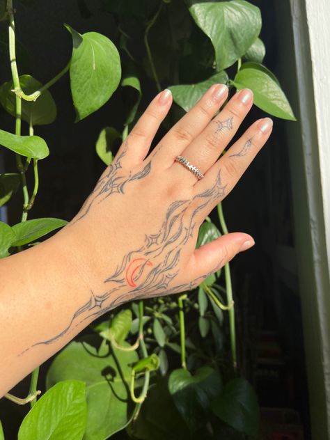 Swirl Finger Tattoo, Red Tattoo On Tan Skin, Red Star Hand Tattoo, Sun Moon Star Hand Tattoo, Starry Hand Tattoo, Moon And Star Hand Tattoo, Hand Holding Moon And Sun Tattoo, Hand Holding Stars Tattoo, Brown Ink Tattoo On Light Skin