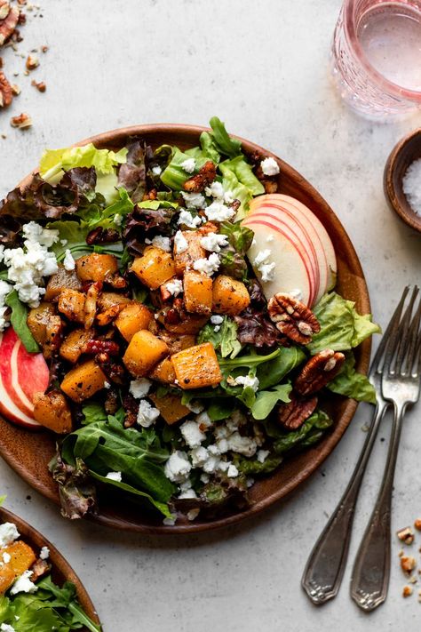 MAPLE ROASTED SQUASH SALAD. The perfect Fall salad, filled with maple pecan roasted butternut squash, four different types of greens, crunchy honey crisp apple slices, and goat cheese crumbles. Tossed with a light homemade dressing sweetened with maple syrup and a touch of cinnamon. #salad #fallrecipes #butternutsquash #saladphotography #healthysalads   |   themindfulhapa.com Cinnamon Salad, Roasted Squash Salad, Pecan Roasted, Roasted Squash Recipes, Goat Cheese Crumbles, Filling Salads, Butternut Squash Cubes, Honey Crisp, Different Salads